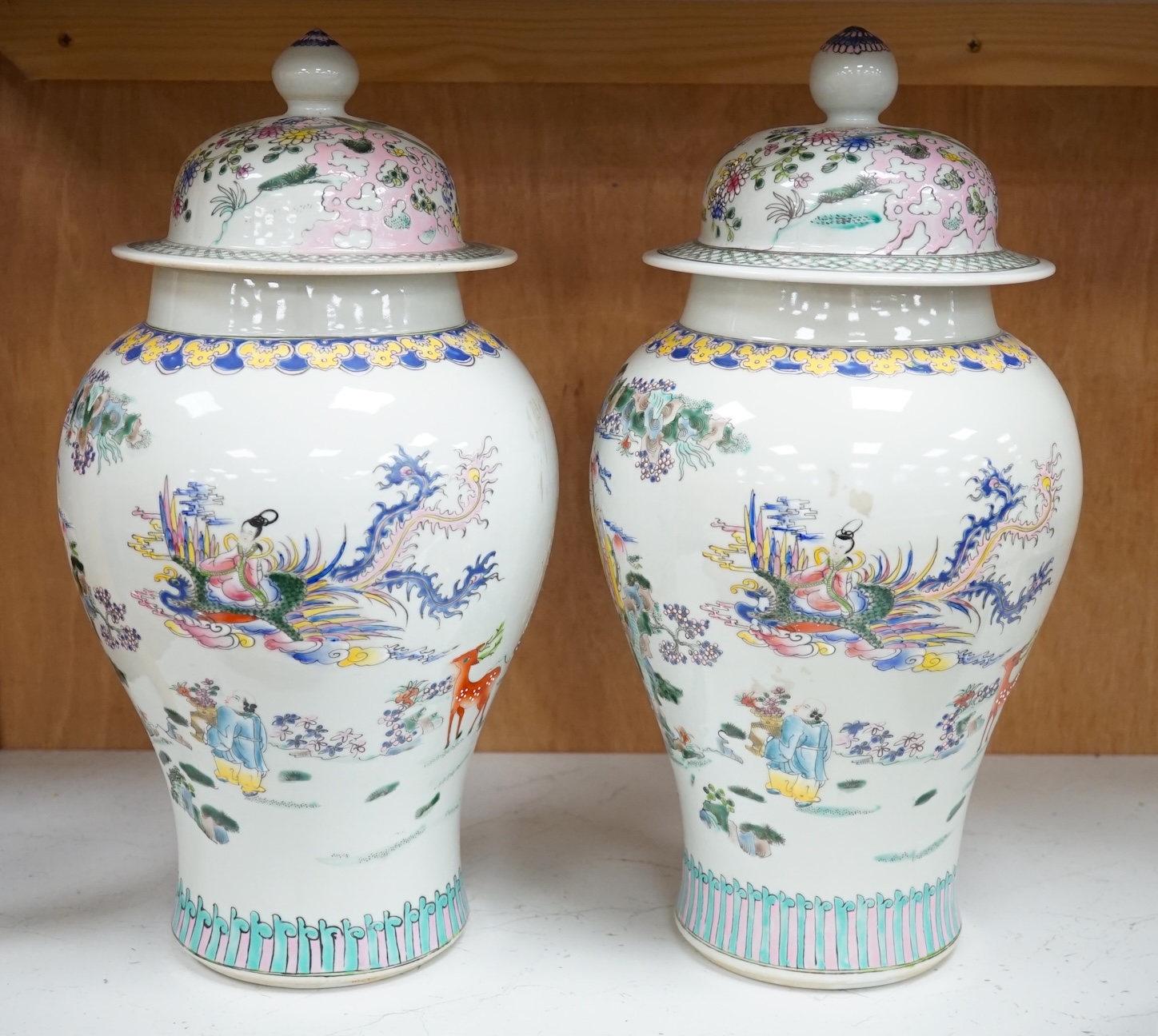 A pair of Chinese famille rose baluster vases and covers, 44cm high. Condition - good